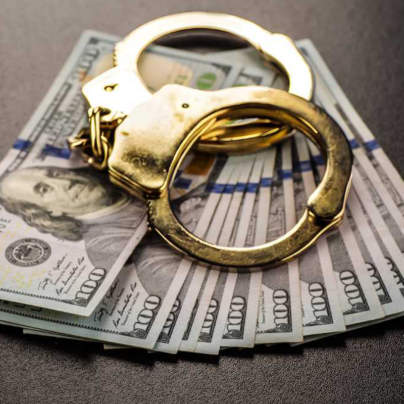 image of golden handcuffs and money